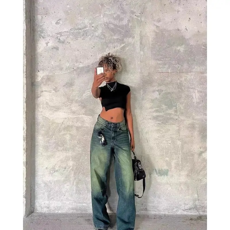Person wearing wide-leg jeans against a concrete wall on a verified product page